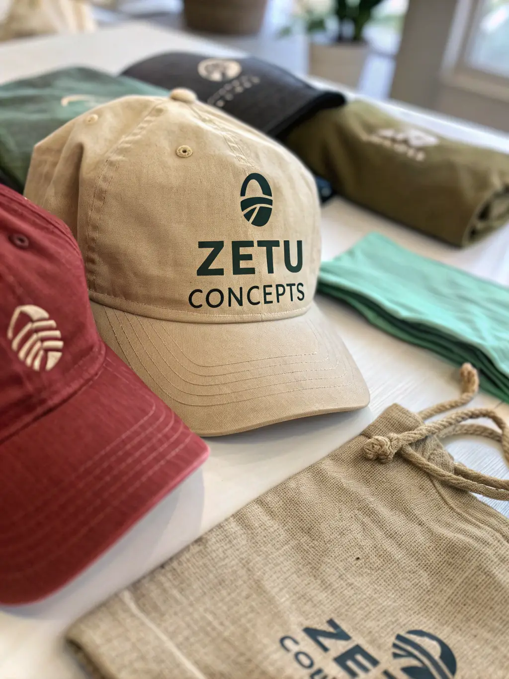 A close-up shot of COEUR LARZAC branded merchandise, such as t-shirts and hats, highlighting the quality and design while promoting the organization's brand.